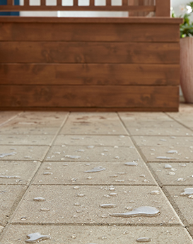 Concrete patio pavers with beading water that proves Thompson’s WaterSeal Clear Multi-Surface Waterproofer is on the job