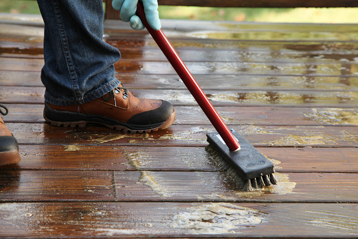 Man Cleaning Deck Prior to Staining Man Cleaning Deck Prior to Staining